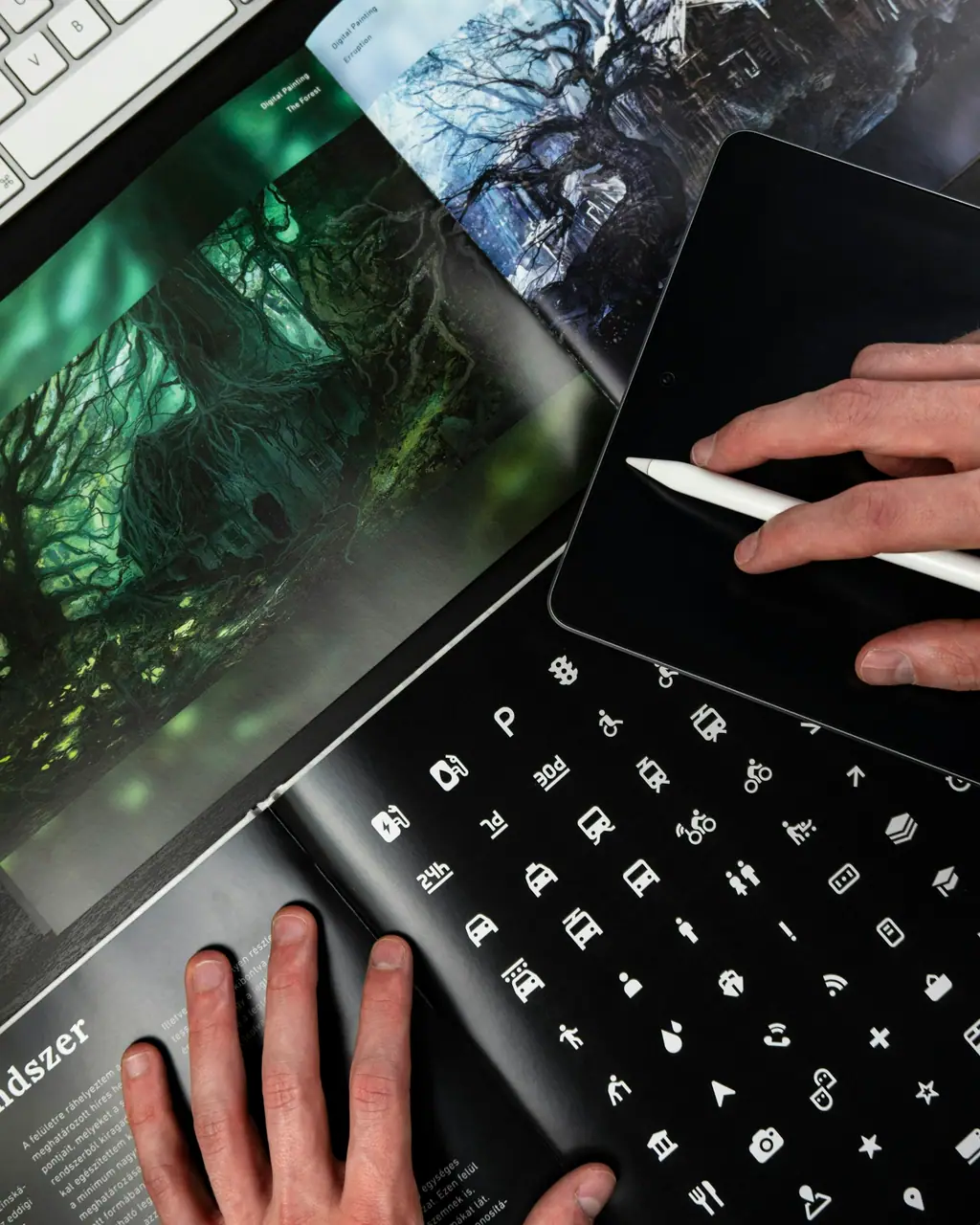 A designer drawing on a tablet with a stylus in a dark studio