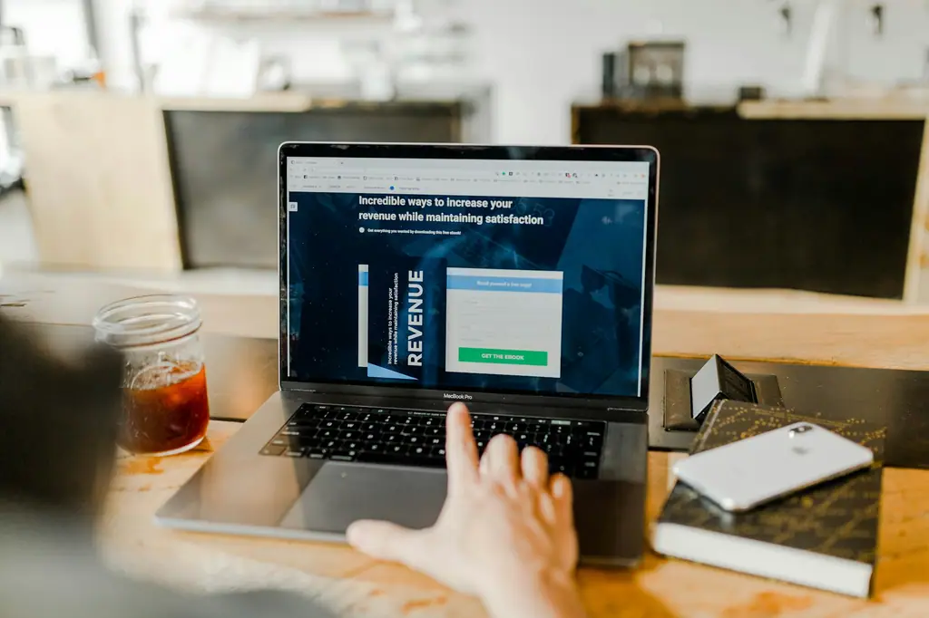 A person reviewing a landing page design on a laptop screen
